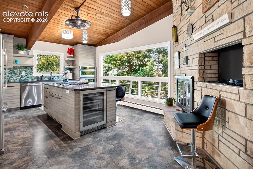 Image 16 of 49: A beverage cooler is at one end of the island.