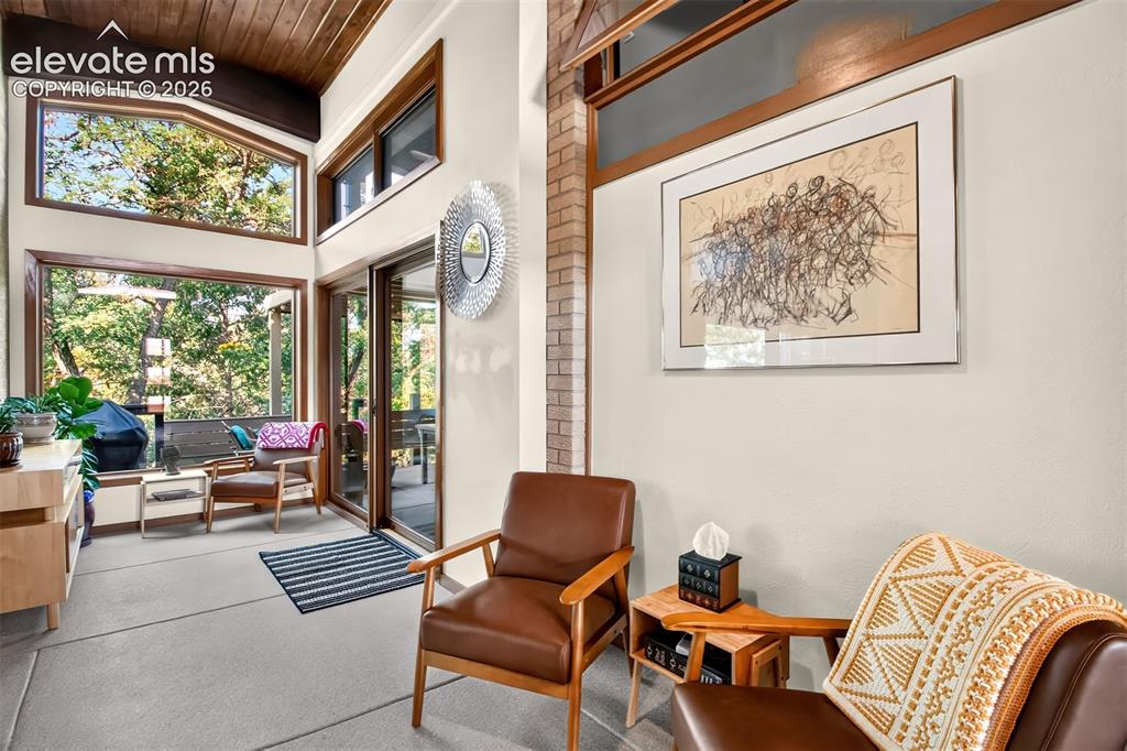 Image 18 of 49: The sunroom opens to the outside  patio
