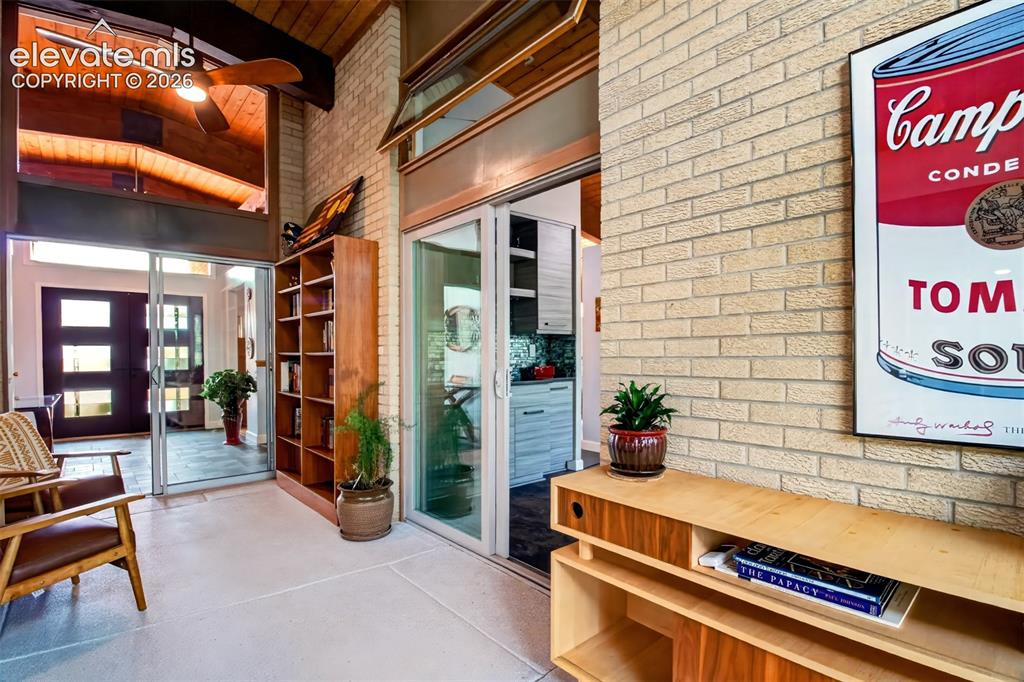 Image 19 of 49: The cozy sun room has epoxy flooring and is a perfect spot to catch an afte
