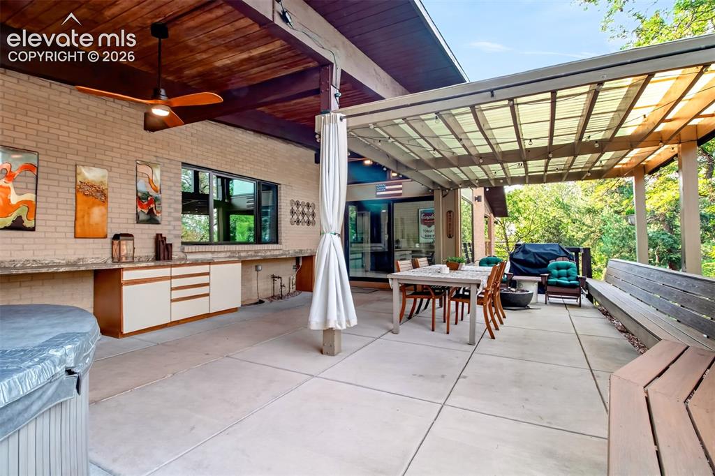 Image 21 of 49: Built in cabinets and countertop along the back of the home serve the cover