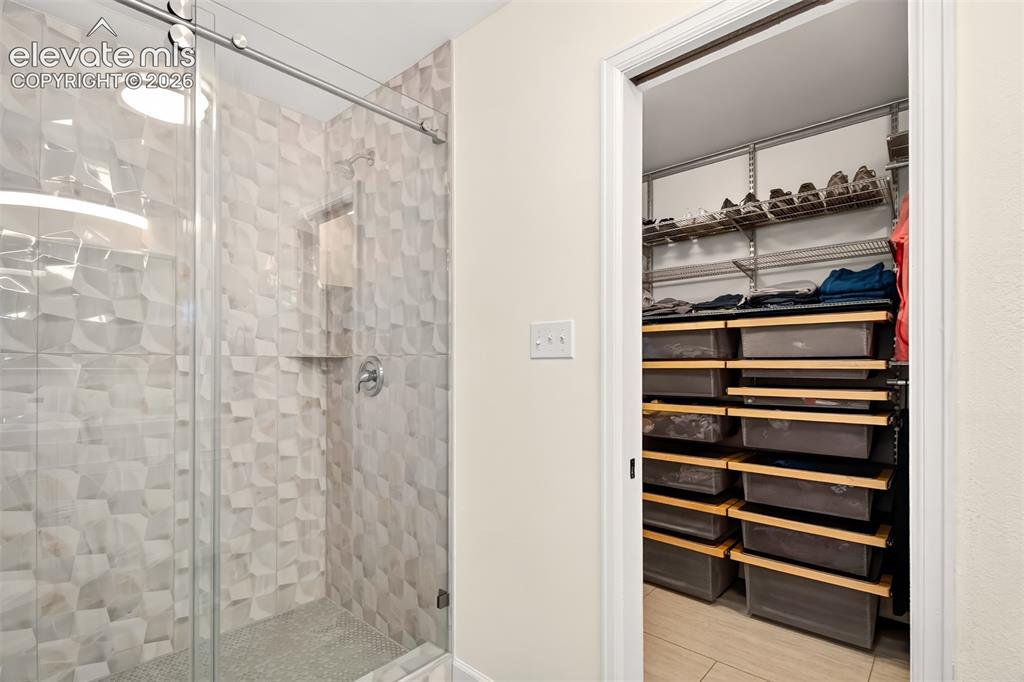 Image 27 of 49: A large luxurious shower in the primary bathroom