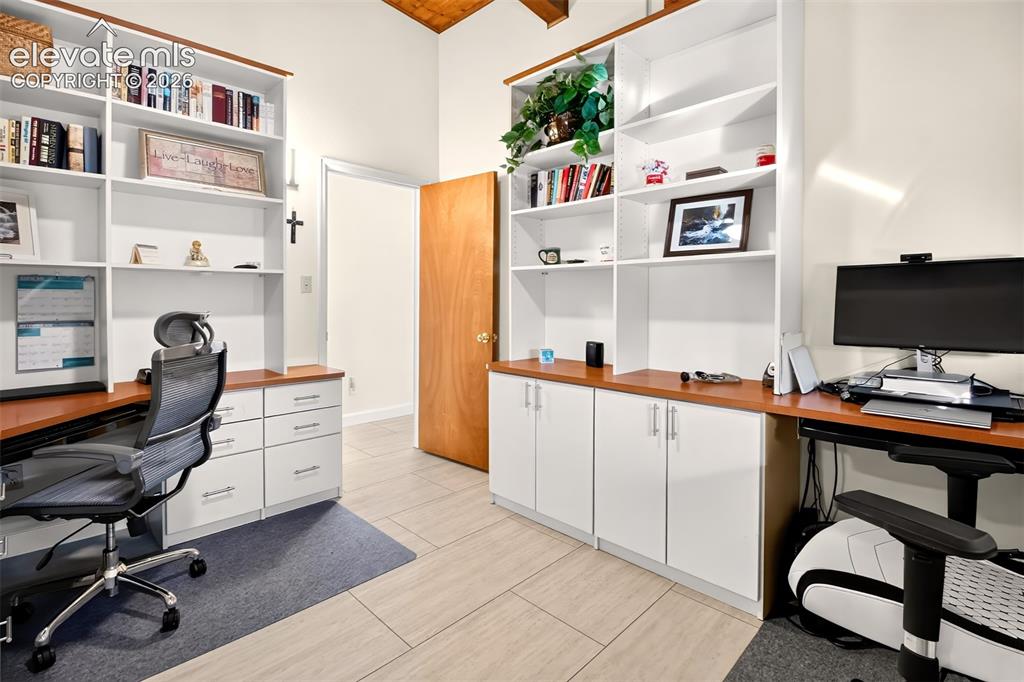 Image 28 of 49: A secondary bedroom currently used as an office