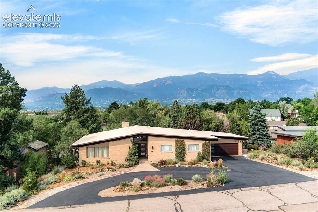 Image 3 of 49: An aerial view of the home with the mountain range as a backdrop! What coul