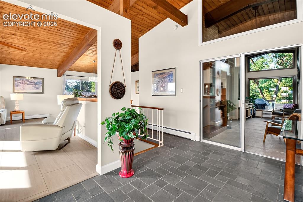 Image 6 of 49: The open floor plan includes slate flooring in the entry and shows the wood