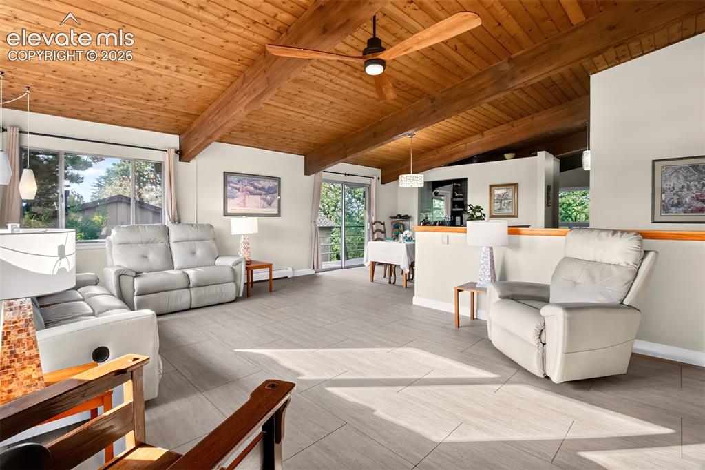 Image 7 of 49: The spacious living room has a luxury vinyl tile flooring.