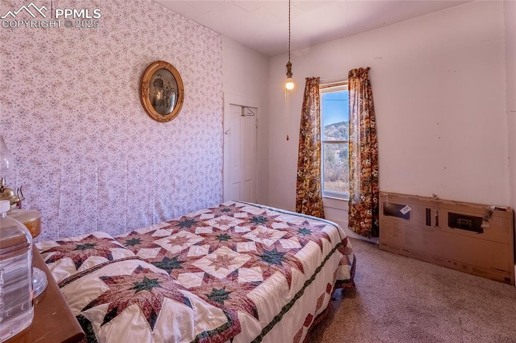 Image 10 of 23: Bedroom featuring carpet and wallpapered walls