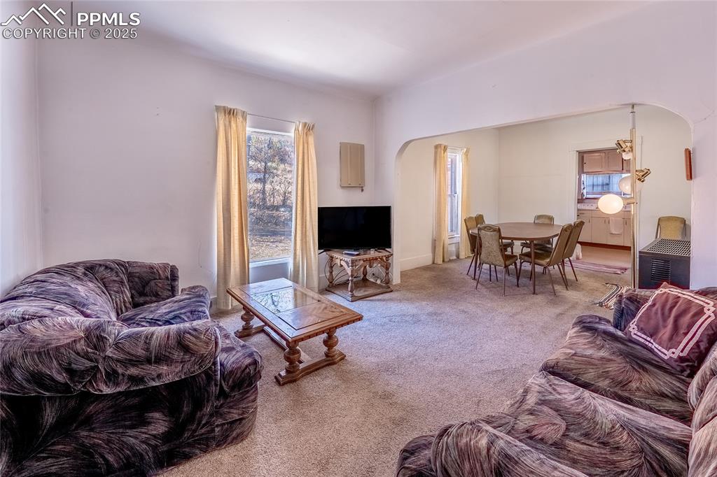Image 3 of 21: Living room featuring arched walkways, healthy amount of natural light, and