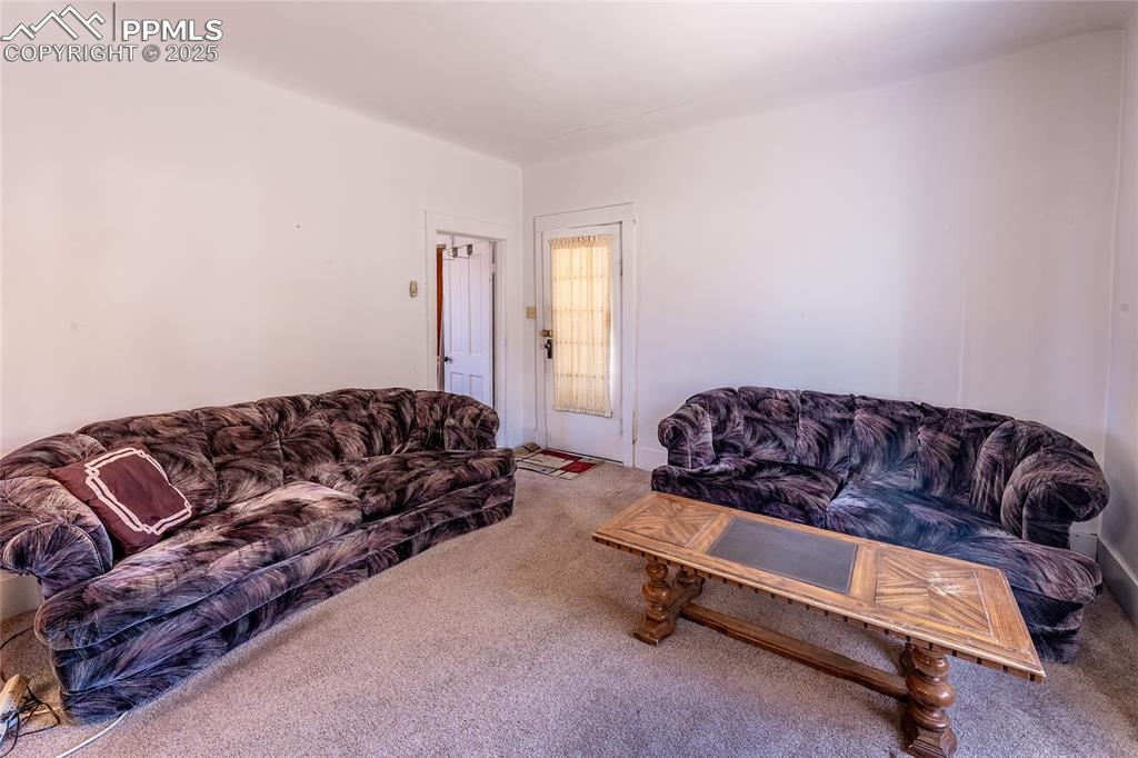 Image 4 of 21: Carpeted living area with baseboards