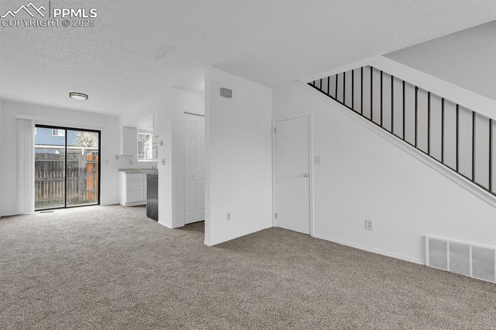 Image 5 of 15: Living Room Flows seamlessly into Dining Space and Kitchen