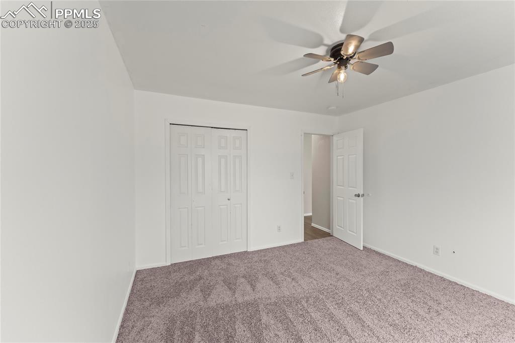 Image 14 of 29: Unfurnished bedroom featuring carpet, a closet, and ceiling fan