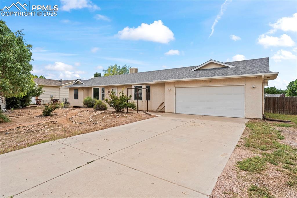 Image 2 of 29: Single story home featuring concrete driveway, roof with shingles, a garage