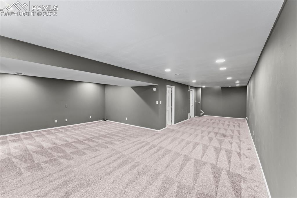 Image 20 of 29: Finished basement with recessed lighting and carpet flooring