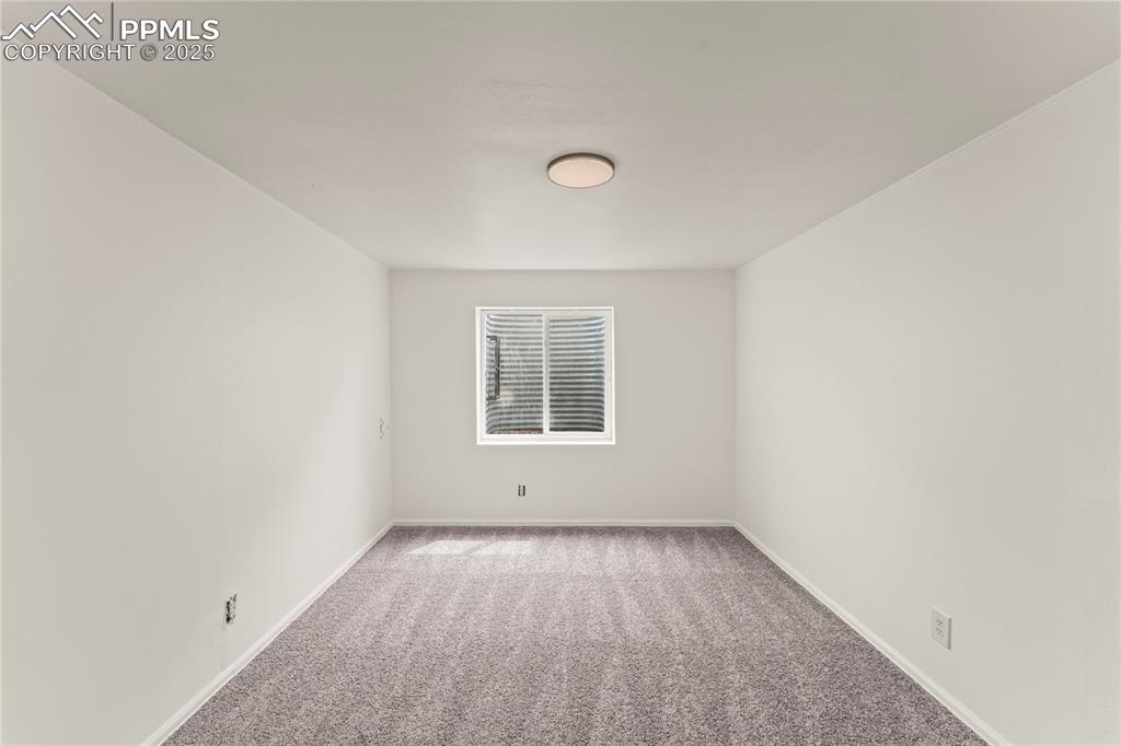 Image 23 of 29: Unfurnished room featuring carpet floors and baseboards