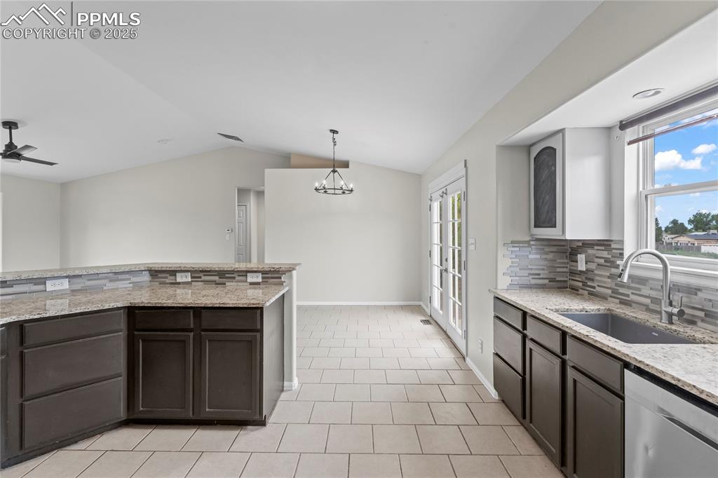 Image 8 of 29: Kitchen featuring tasteful backsplash, stainless steel dishwasher, light st