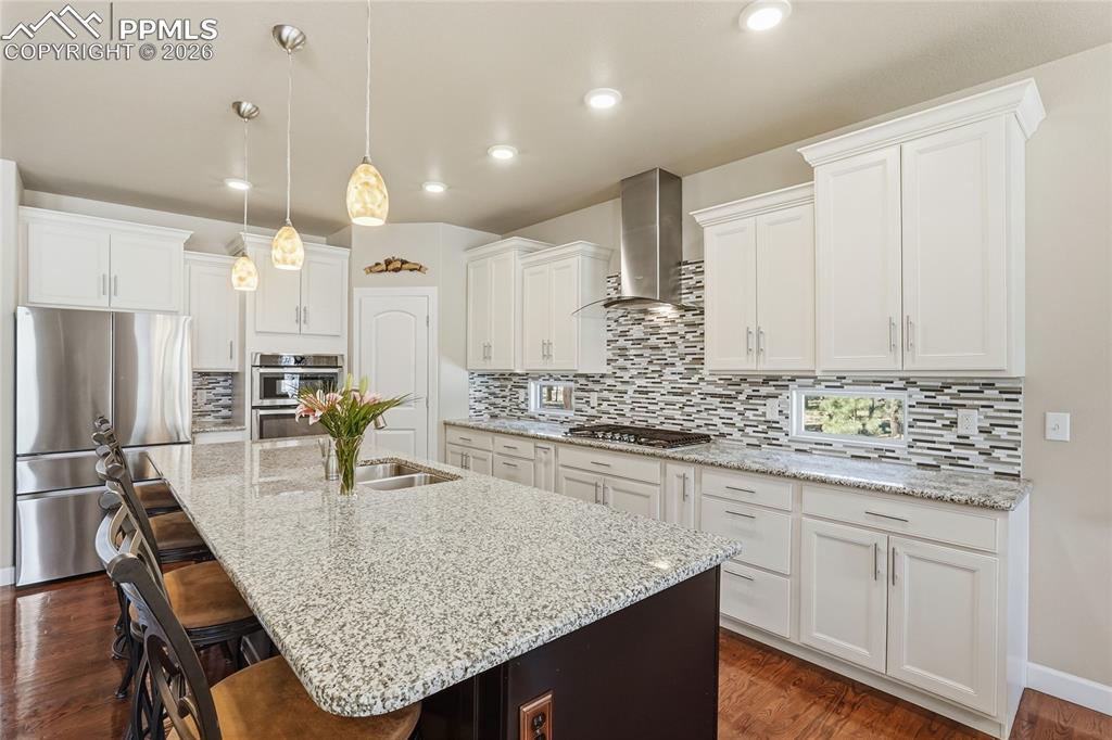 Image 10 of 45: Gas Stove Top and Range Hood