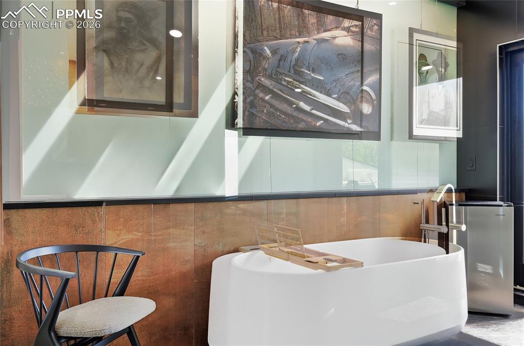 Image 33 of 50: Primary Suite Features Sliding Door Company Doors