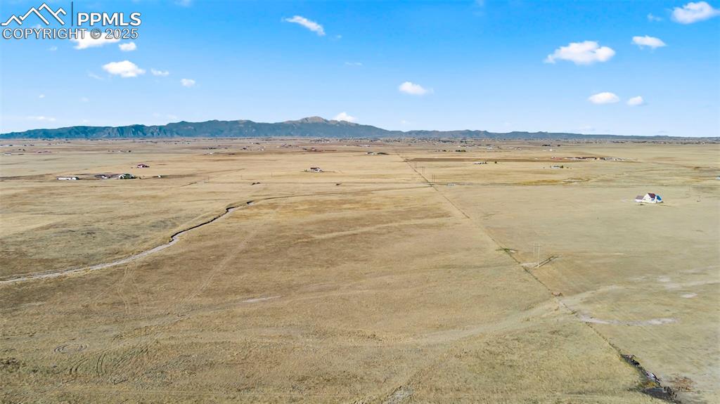 Image 8 of 10: View of rural area featuring a desert landscape and mountains