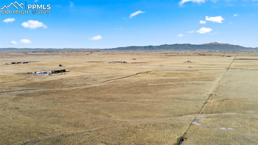 Image 9 of 10: View of rural area featuring a desert landscape and mountains