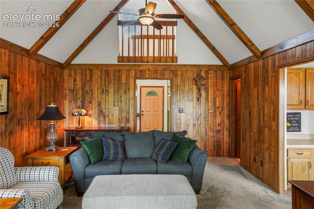 Image 13 of 39: The living room delivers that classic mountain cabin feel with vaulted, bea