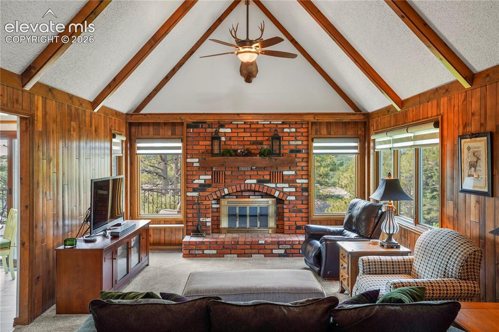 Image 14 of 39: a brick wood-burning fireplace, upgraded blinds, wood mantle, and more swe