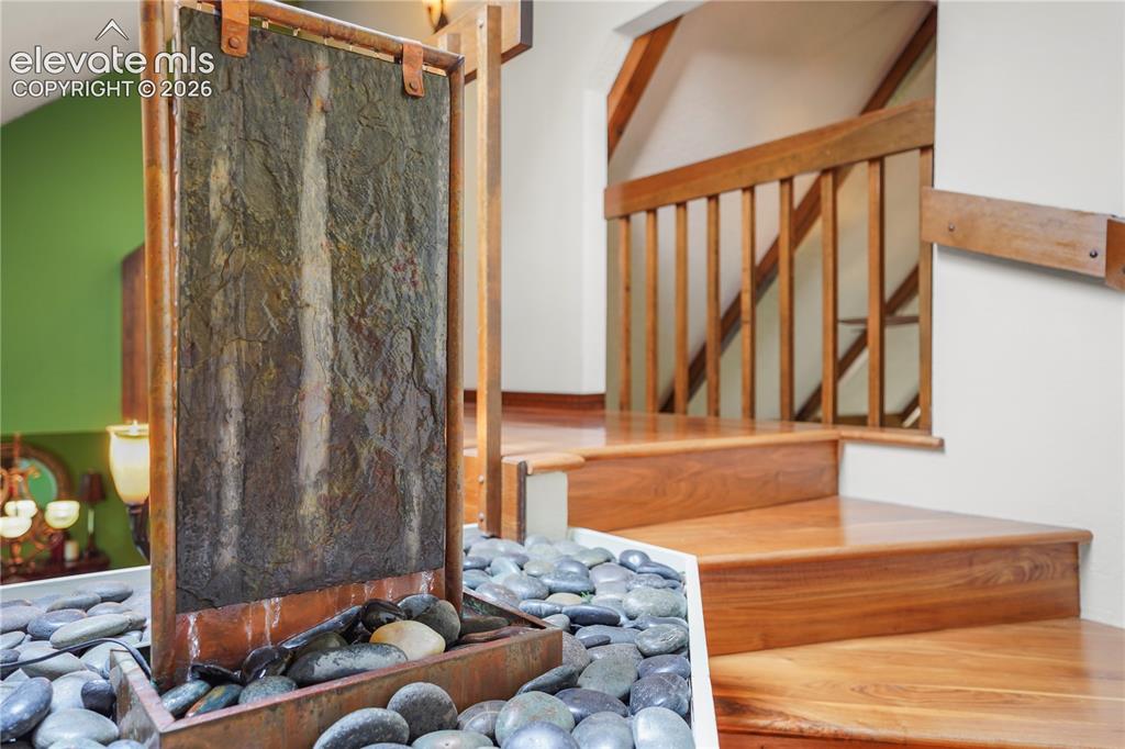 Image 18 of 39: Copper and slate water feature with rock surroundings as you climb the stai