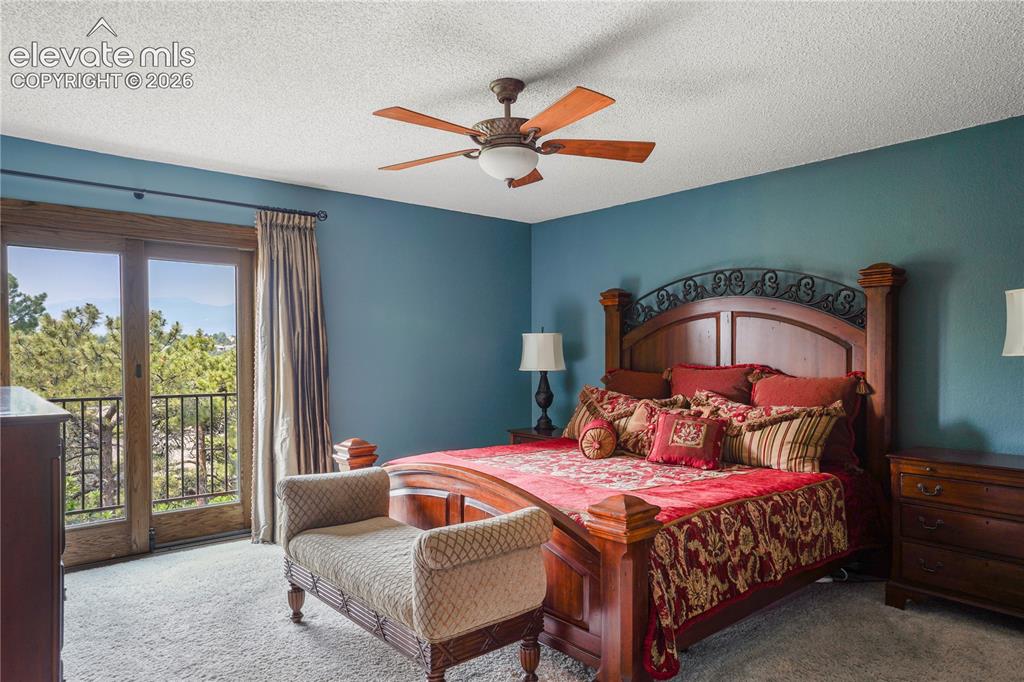 Image 20 of 39: Primary bedroom suite with walkout to private balcony and attached 3/4 bath