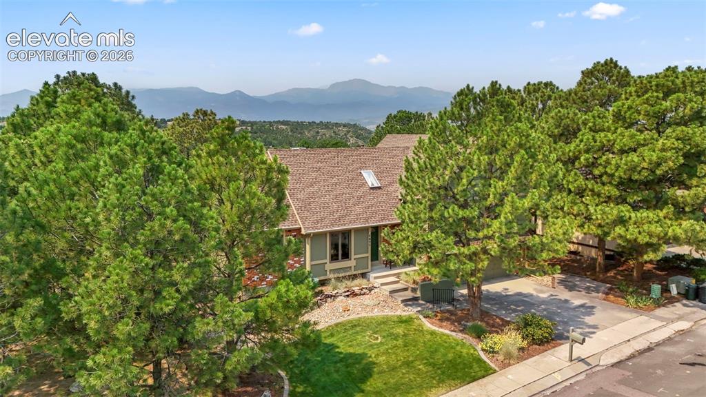 Image 37 of 39: with beautiful established landscaping, an updated roof, newer deck, window