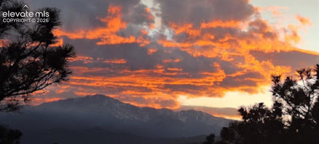 Image 38 of 39: Sunset view of Pikes Peak from deck