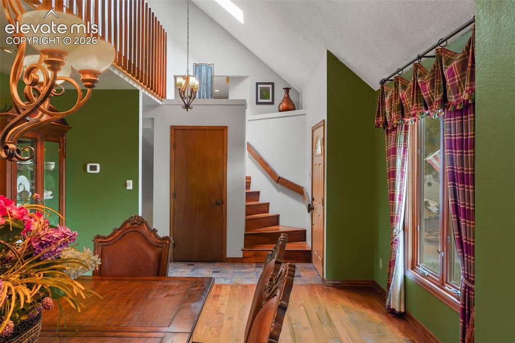 Image 4 of 39: Step inside to rich black walnut floors and decorative tile, newer Anderson