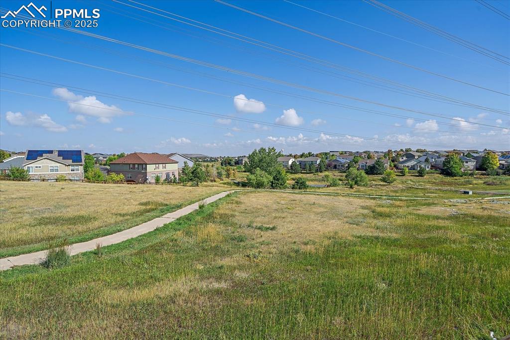 Image 28 of 49: View of grassy yard featuring a residential view
