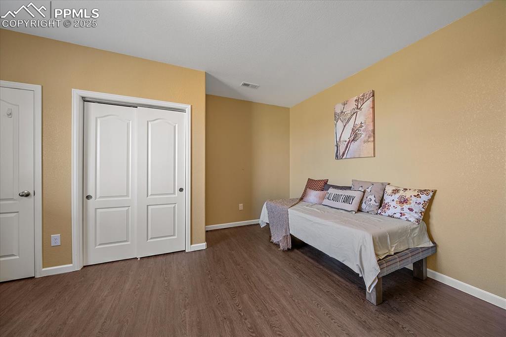 Image 36 of 49: Bedroom in basement featuring luxury vinyl  flooring and a closet