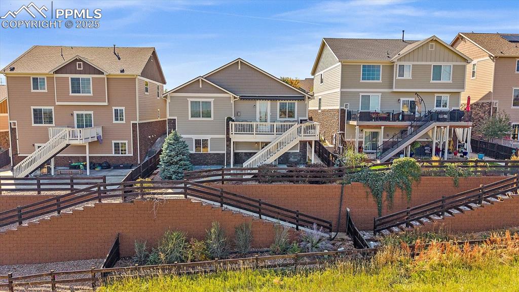 Image 40 of 49: View of play area with a residential view, stairs, and a fenced backyard