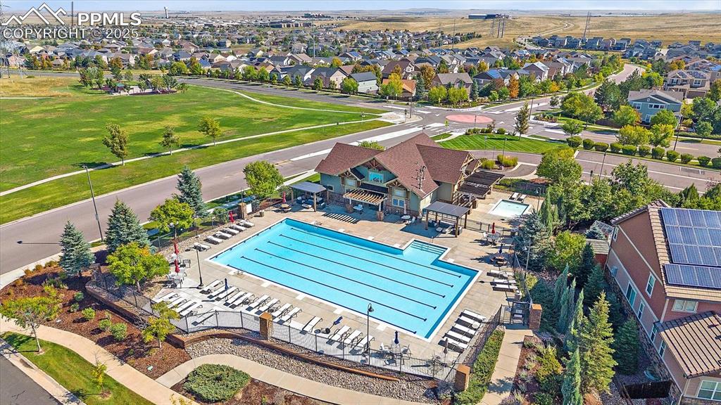 Image 45 of 49: Aerial view of residential area with a pool area