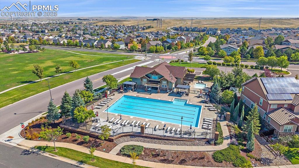 Image 46 of 49: Aerial perspective of suburban area with a pool area