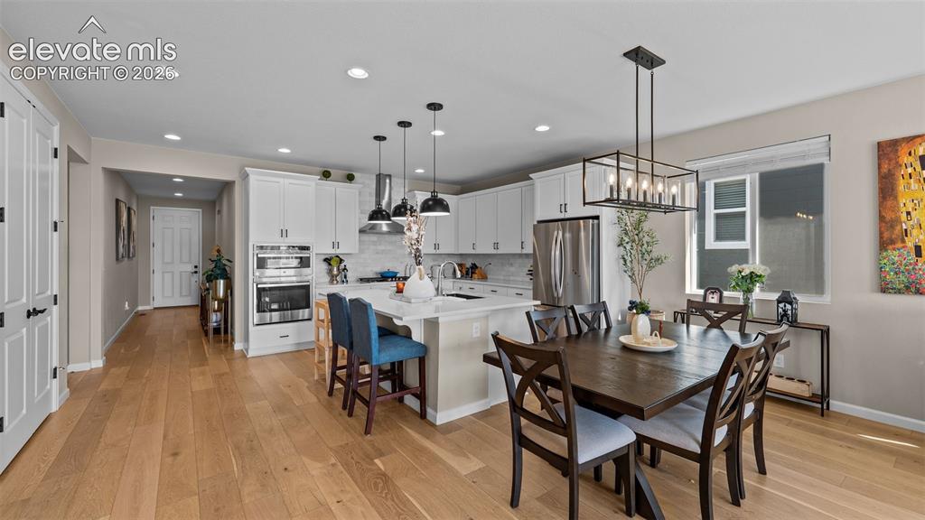 Image 11 of 46: Gourmet kitchen featuring white cabinetry, stainless steel appliances, and 