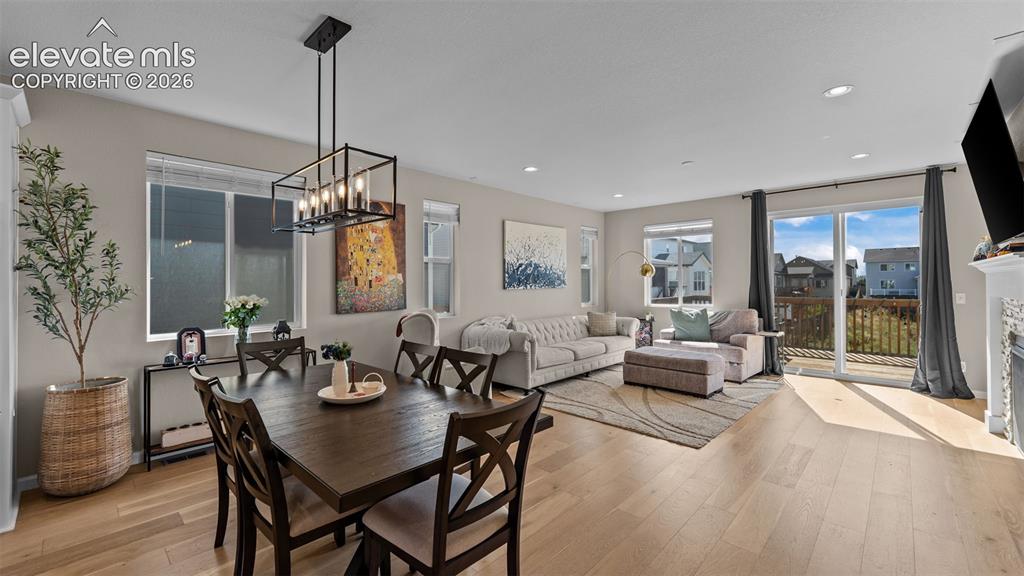 Image 12 of 46: Open-concept living space featuring wood-finish flooring, recessed lighting