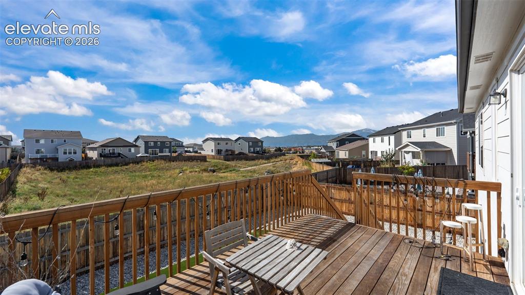 Image 19 of 46: Expansive wood deck with a full wood railing and built-in privacy fence