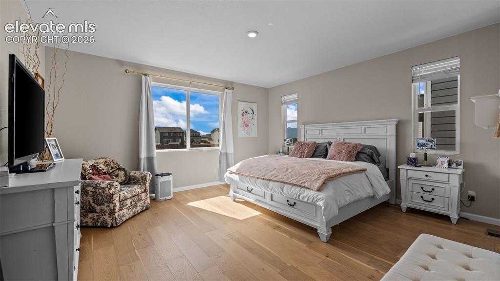 Image 20 of 46: Recessed lighting, wood-finish flooring, and multiple windows