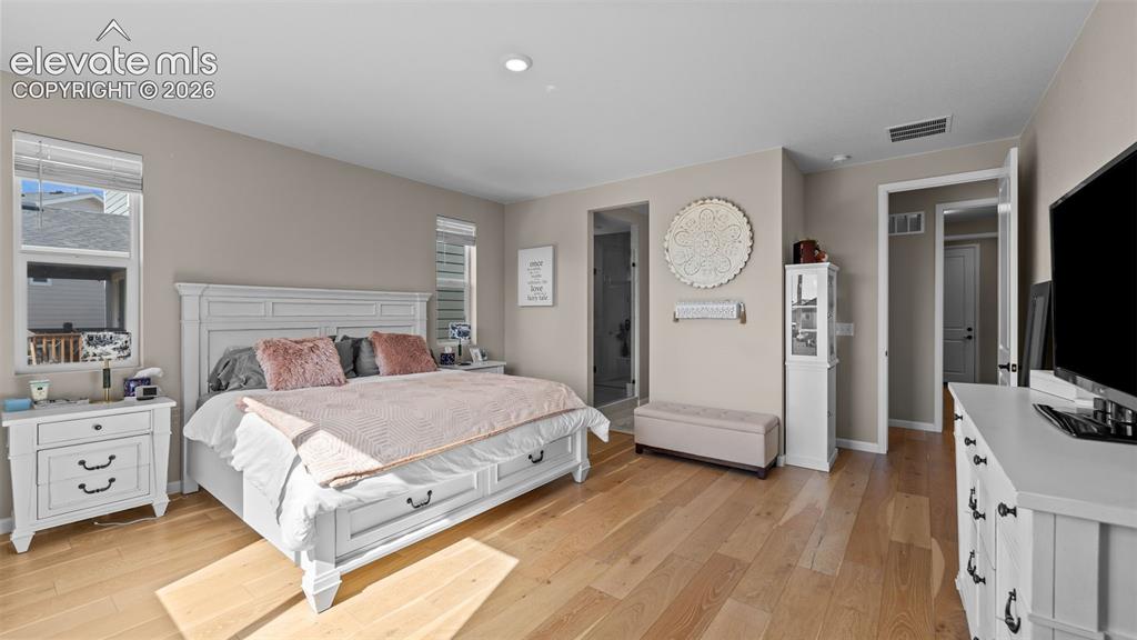 Image 21 of 46: Hardwood-finish flooring, recessed lighting, and neutral wall tones