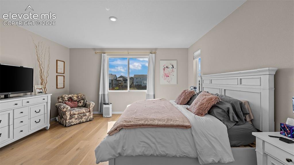 Image 25 of 46: Wood-finish flooring with neutral wall tones and recessed lighting