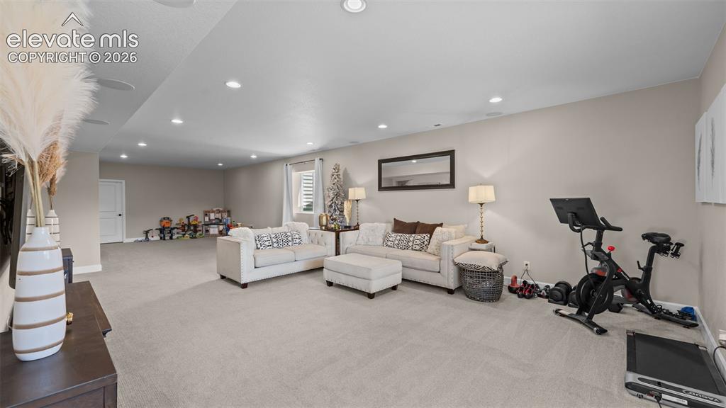 Image 26 of 46: Expansive open-concept room featuring recessed lighting, light-toned carpet