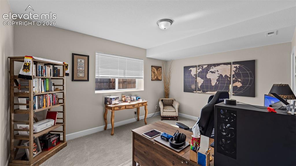 Image 30 of 46: Neutral wall paint, plush carpet flooring, window with horizontal blinds, o