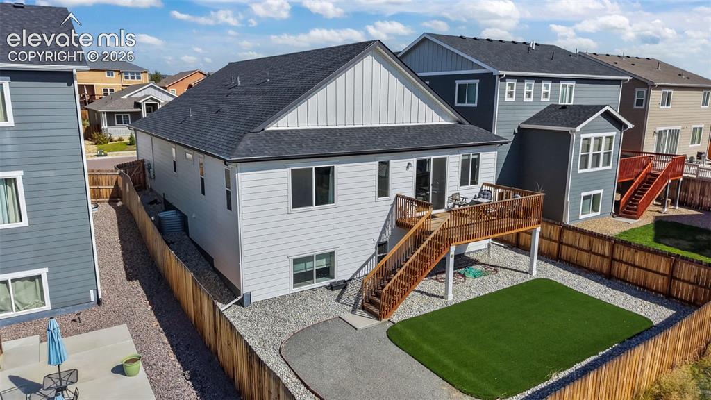 Image 35 of 46: Upper-level wood deck with staircase, sliding glass door access, fenced per