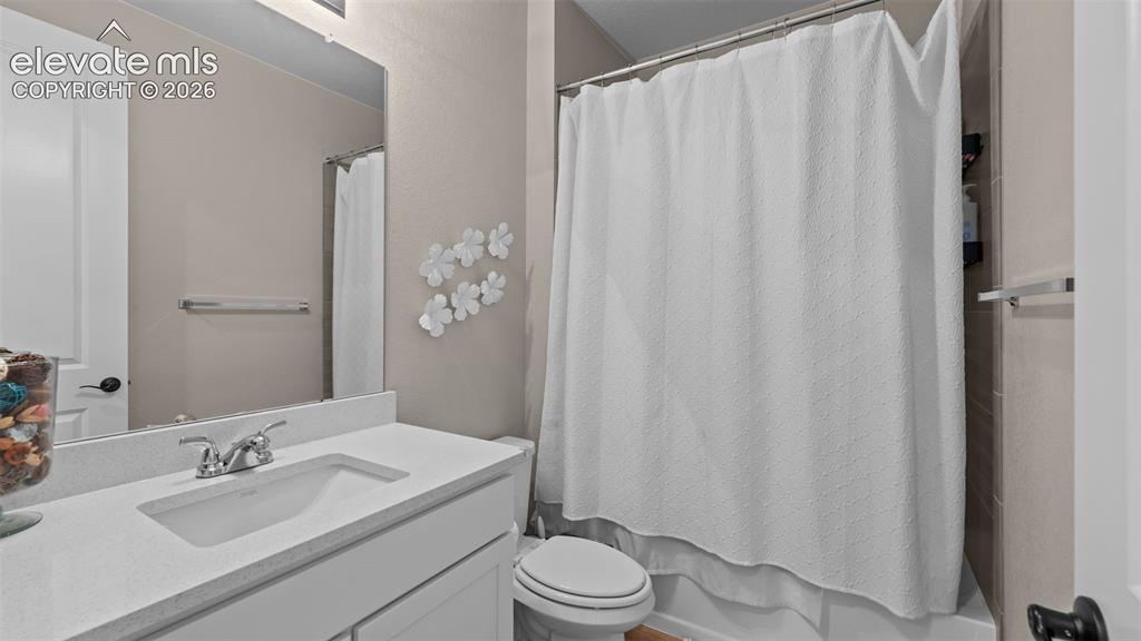 Image 6 of 46: Built-in vanity with a single basin sink and a chrome-finish faucet