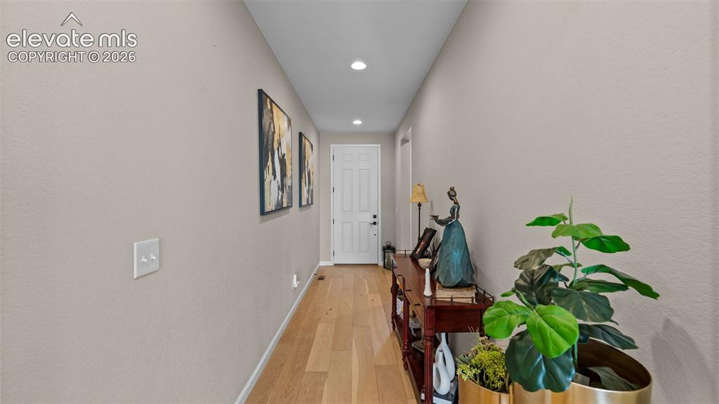 Image 8 of 46: Recessed lighting illuminates wood-finish flooring