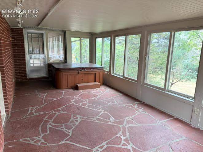 Image 14 of 27: Lovely sunroom off the living room and the hot tub stays!