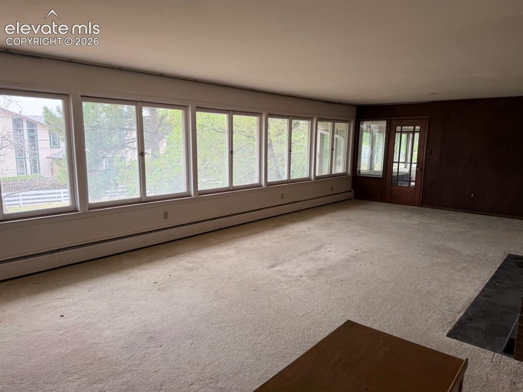 Image 3 of 26: Spacious living room with huge wall of windows to let that natural light in