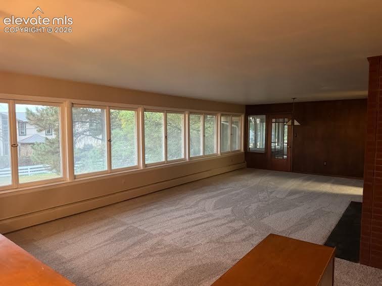 Image 4 of 27: Spacious living room with huge wall of windows to let that natural light in