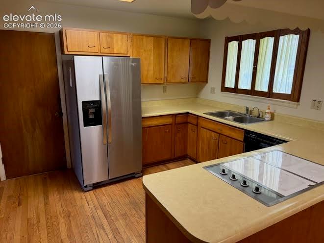 Image 5 of 27: Stainless refrigerator and hardwood floors