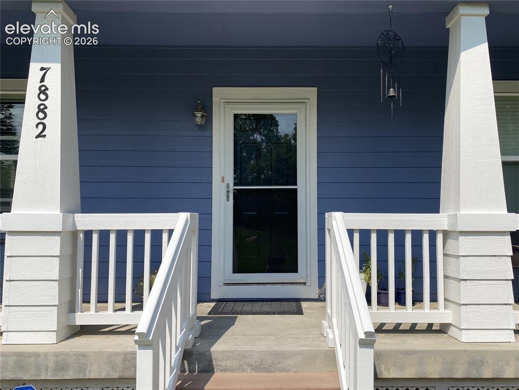 Image 11 of 40: With newly painted porch railings, the home offers a welcoming entry